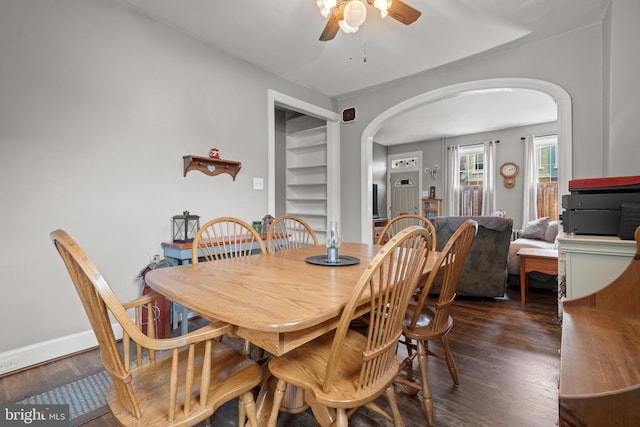 848 Houston St, Columbia, PA 17512 - dining area featuring arched walkways, a ceiling fan, dark wood finished floors, and baseboards