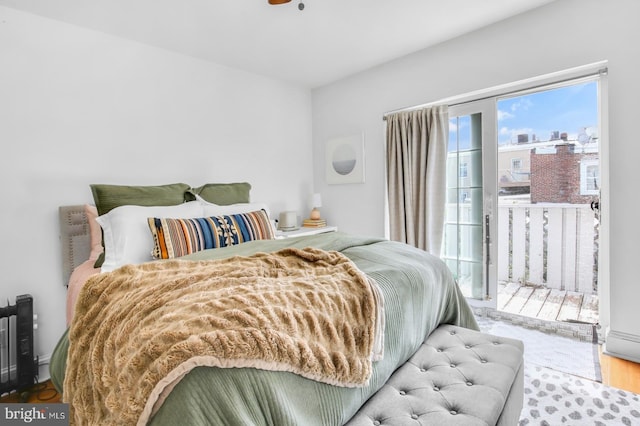 bedroom featuring wood finished floors and access to outside