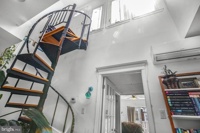 staircase with a ceiling fan