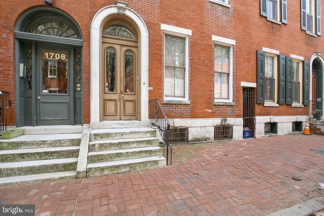 doorway to property with brick siding
