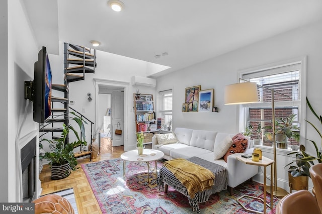 living room featuring an AC wall unit, stairway, and a fireplace with flush hearth