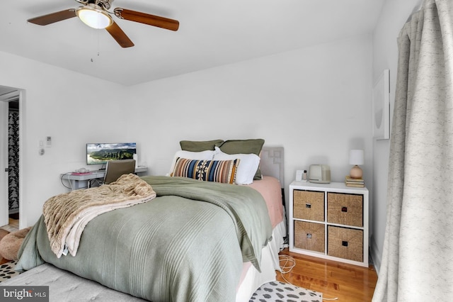 bedroom with wood finished floors and a ceiling fan