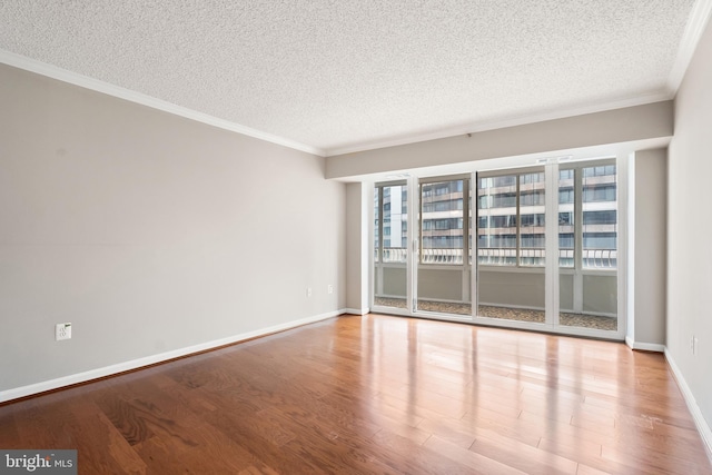 1300 Crystal Dr Unit 1408S, Arlington, VA 22202 - unfurnished room with a textured ceiling, plenty of natural light, wood finished floors, crown molding, and baseboards