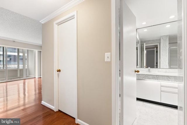 1300 Crystal Dr Unit 1408S, Arlington, VA 22202 - corridor with a sink, recessed lighting, ornamental molding, baseboards, and wood finished floors