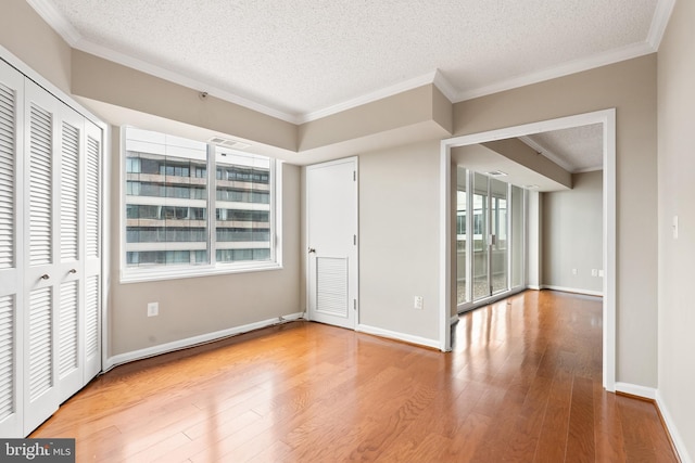 1300 Crystal Dr Unit 1408S, Arlington, VA 22202 - unfurnished bedroom featuring a textured ceiling, wood finished floors, ornamental molding, and baseboards
