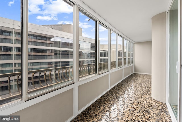 1300 Crystal Dr Unit 1408S, Arlington, VA 22202 - unfurnished sunroom featuring baseboards and stone finish flooring