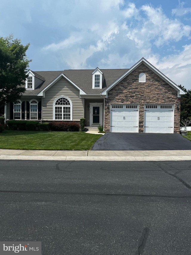 31142 Mills Chase Dr Unit 9, Lewes, DE 19958 - view of front of home with driveway, stone siding, a front lawn, a garage, and a shingled roof