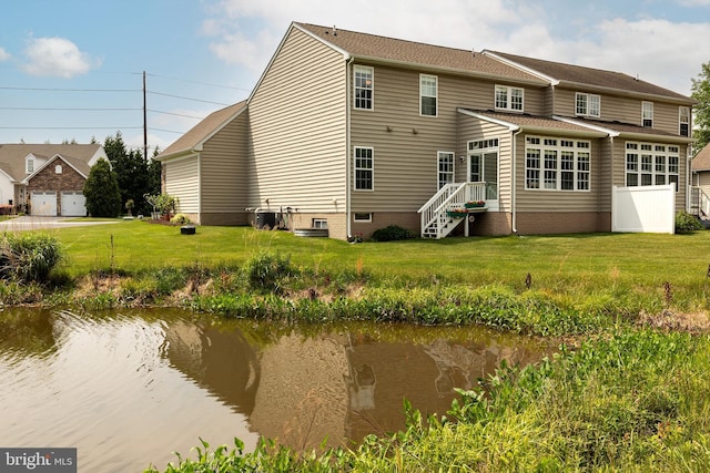 31142 Mills Chase Dr Unit 9, Lewes, DE 19958 - rear view of property featuring central AC and a lawn
