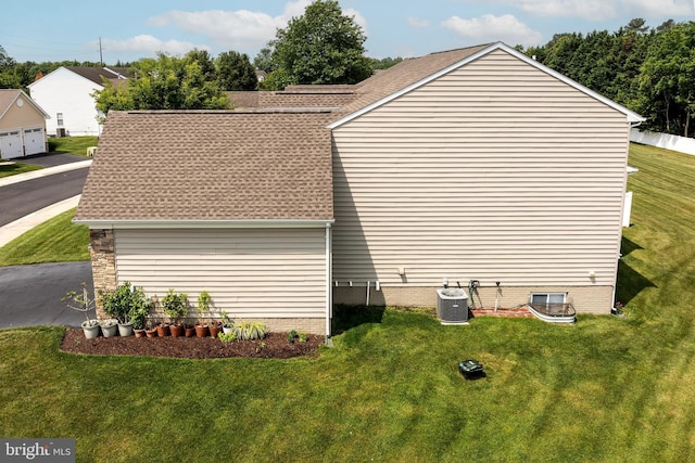 31142 Mills Chase Dr Unit 9, Lewes, DE 19958 - view of property exterior featuring a lawn, cooling unit, and roof with shingles