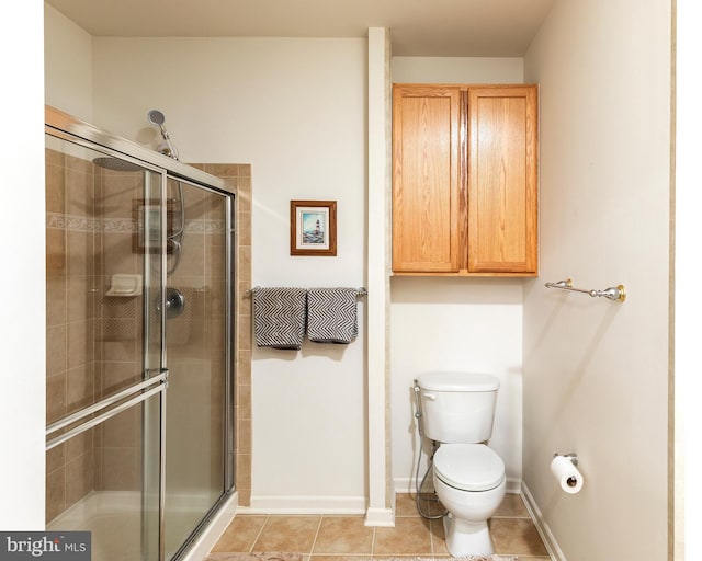 31142 Mills Chase Dr Unit 9, Lewes, DE 19958 - bathroom with a shower stall, baseboards, toilet, and tile patterned flooring