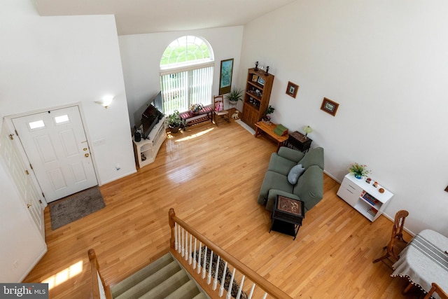 31142 Mills Chase Dr Unit 9, Lewes, DE 19958 - living room with light wood-type flooring, high vaulted ceiling, and stairway