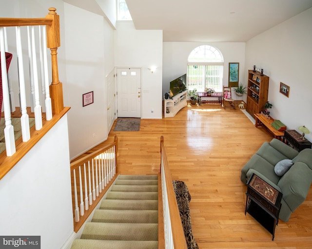 31142 Mills Chase Dr Unit 9, Lewes, DE 19958 - staircase with wood finished floors and high vaulted ceiling
