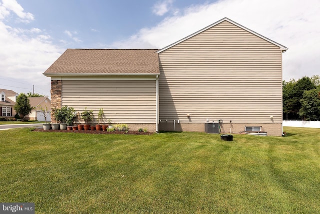 31142 Mills Chase Dr Unit 9, Lewes, DE 19958 - view of property exterior with a yard, central AC, and roof with shingles