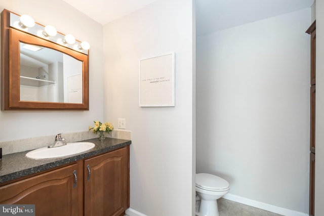 225 S Hanover St, Pottstown, PA 19465 - bathroom with baseboards, vanity, toilet, and tile patterned floors