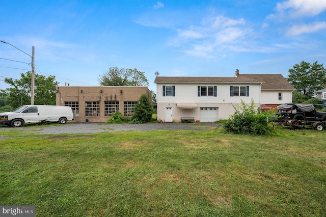 225 S Hanover St, Pottstown, PA 19465 - back of house with a garage, a yard, and gravel driveway