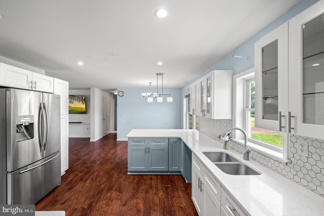225 S Hanover St, Pottstown, PA 19465 - kitchen featuring stainless steel fridge, a sink, white cabinetry, glass insert cabinets, and tasteful backsplash