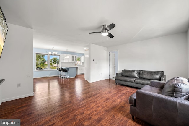 225 S Hanover St, Pottstown, PA 19465 - living area with a chandelier, a ceiling fan, dark wood-style flooring, and baseboards