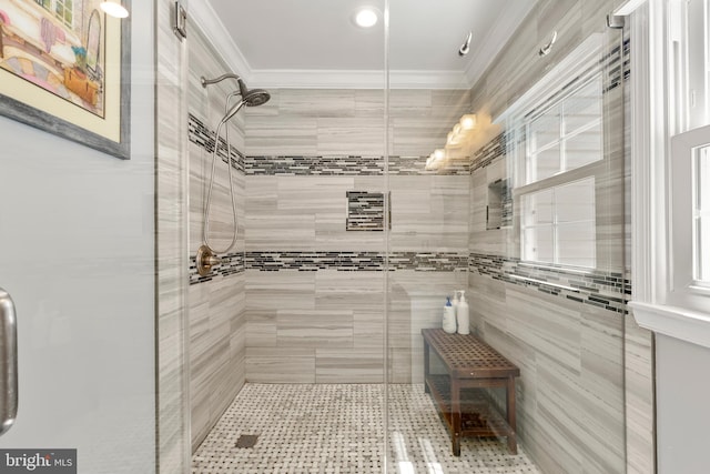 full bathroom with crown molding and a shower stall