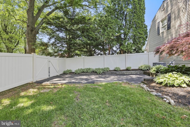 view of yard featuring a patio and a gate