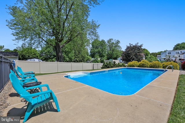 view of pool featuring fence and a patio