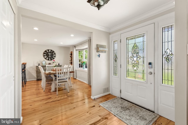 entrance foyer featuring ornamental molding, light wood-style floors, baseboards, and recessed lighting