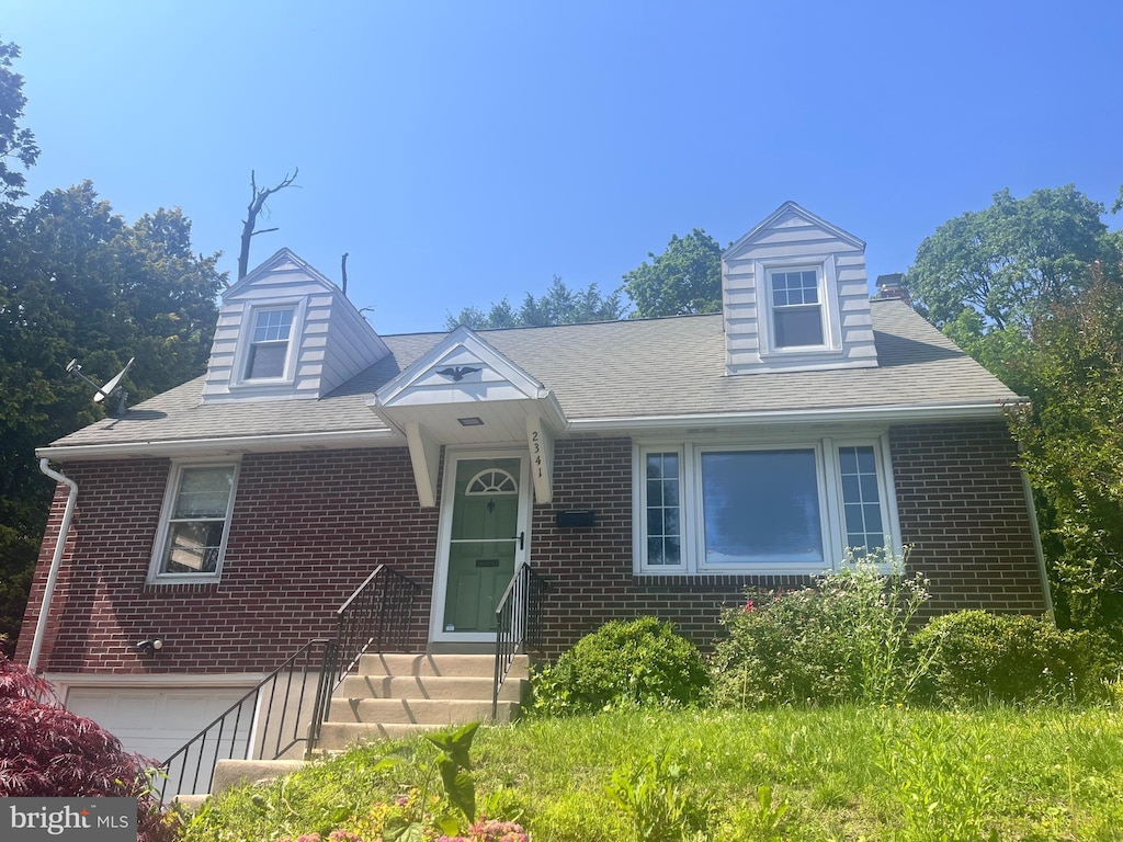 2341 Highland St, Reading, PA 19609 - new england style home with brick siding, a garage, and roof with shingles