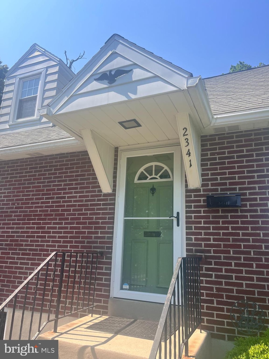 2341 Highland St, Reading, PA 19609 - doorway to property with brick siding and roof with shingles