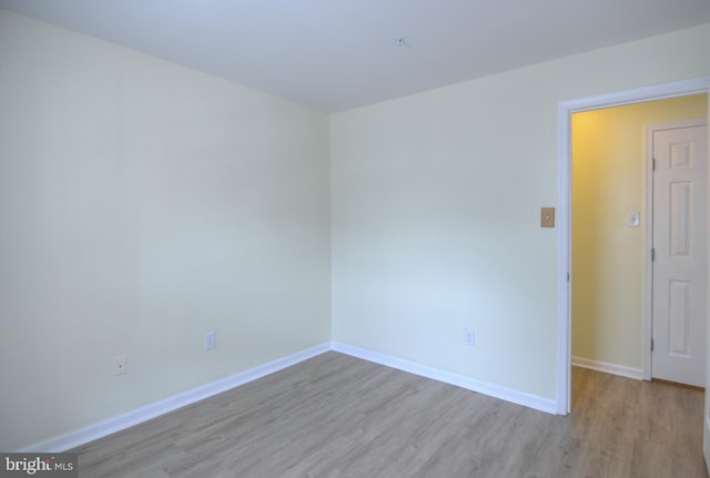 unfurnished room featuring wood finished floors and baseboards