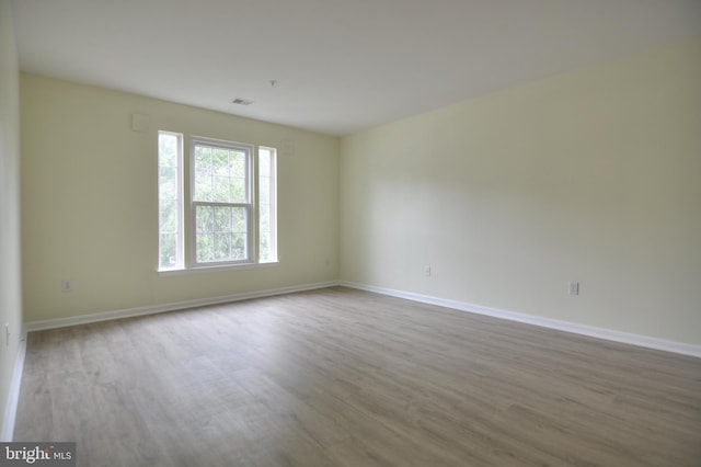 empty room with wood finished floors and baseboards
