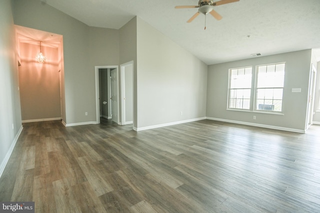 unfurnished living room with vaulted ceiling, a ceiling fan, baseboards, and wood finished floors