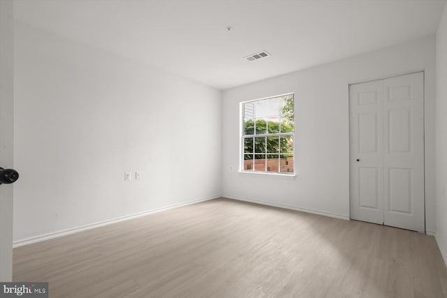 unfurnished bedroom featuring wood finished floors and baseboards