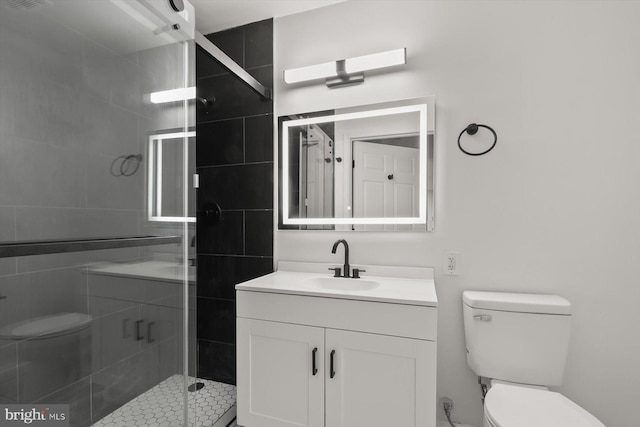 full bath featuring toilet, vanity, and a stall shower