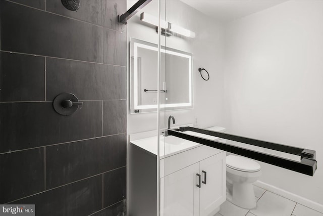 full bath with tile patterned floors, toilet, vanity, and a tile shower