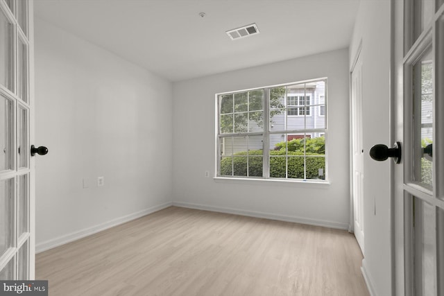 empty room featuring light wood-style flooring and baseboards
