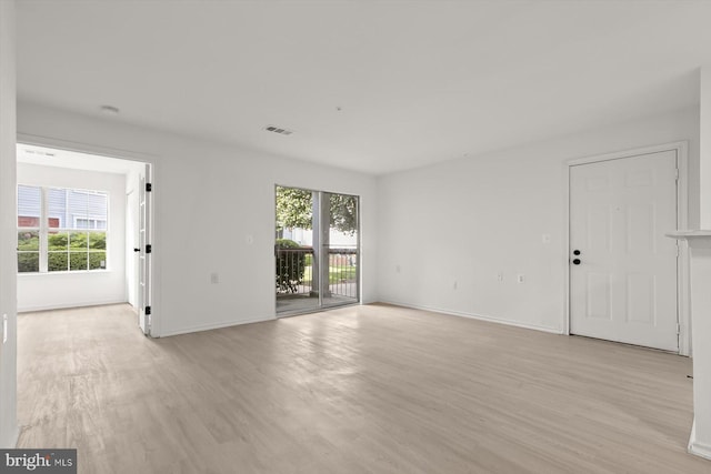 unfurnished living room with light wood-style floors and baseboards