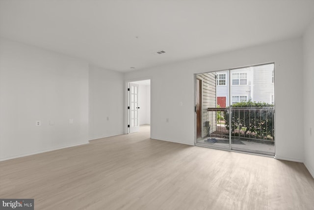 empty room featuring light wood-style floors and baseboards