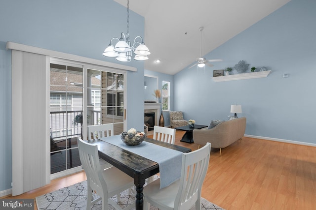 12708 Found Stone Rd Unit 3-304, Germantown, MD 20876 - dining area with high vaulted ceiling, a glass covered fireplace, a chandelier, wood finished floors, and ceiling fan
