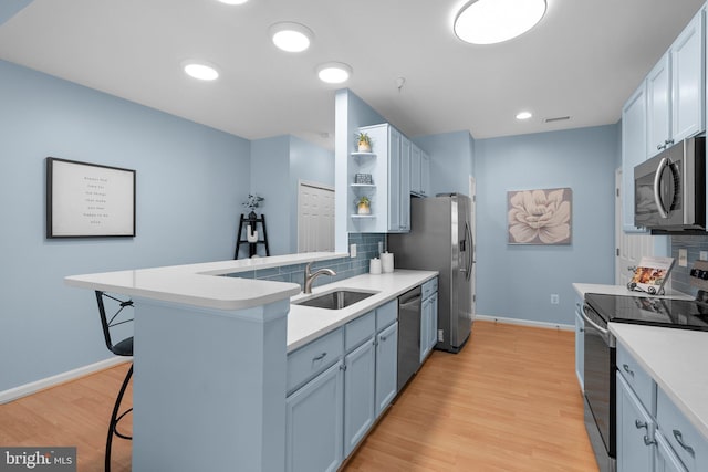 12708 Found Stone Rd Unit 3-304, Germantown, MD 20876 - kitchen featuring appliances with stainless steel finishes, a kitchen bar, open shelves, tasteful backsplash, and a peninsula