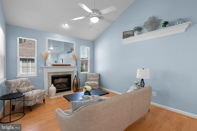 12708 Found Stone Rd Unit 3-304, Germantown, MD 20876 - living area featuring a tile fireplace, ceiling fan, wood finished floors, plenty of natural light, and high vaulted ceiling