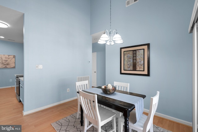 12708 Found Stone Rd Unit 3-304, Germantown, MD 20876 - dining area featuring a chandelier, light wood finished floors, and a high ceiling