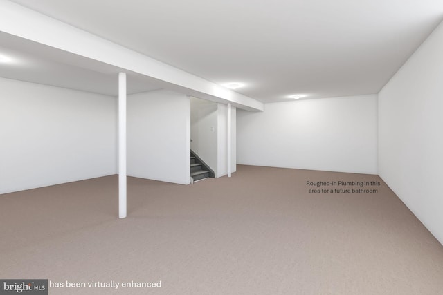 finished basement featuring carpet flooring and stairway