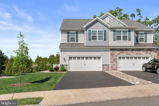 view of front of property featuring asphalt driveway, stone siding, an attached garage, and a front lawn