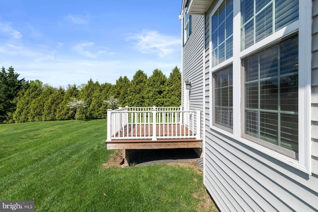 view of green lawn with a deck