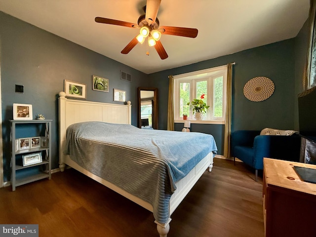 bedroom with dark wood-style floors, baseboards, and ceiling fan