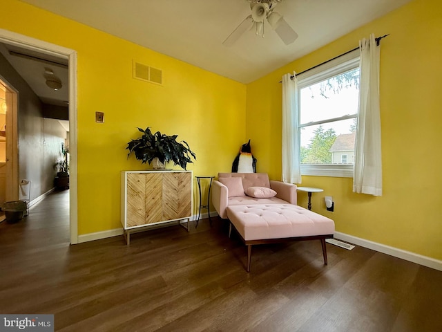 sitting room featuring wood finished floors, baseboards, and ceiling fan