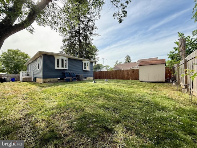 back of property with a storage shed, central AC, and an outdoor structure