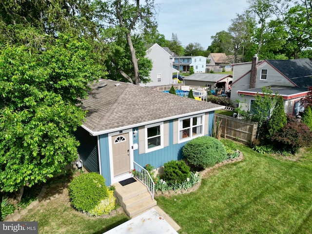 view of front of home featuring roof with shingles, a residential view, and entry steps