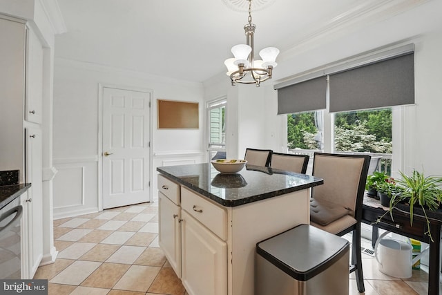 6410 Brass Button Ct, Centreville, VA 20121 - kitchen with a chandelier, crown molding, pendant lighting, dark stone countertops, and a center island