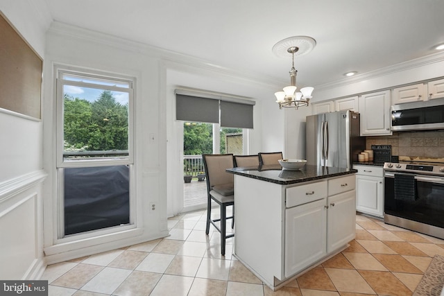 6410 Brass Button Ct, Centreville, VA 20121 - kitchen with stainless steel appliances, crown molding, a chandelier, decorative backsplash, and white cabinets