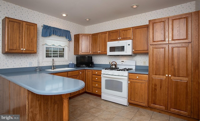 125 Wyndham Way, Harrisburg, PA 17109 - kitchen featuring white appliances, wallpapered walls, a sink, brown cabinets, and a peninsula